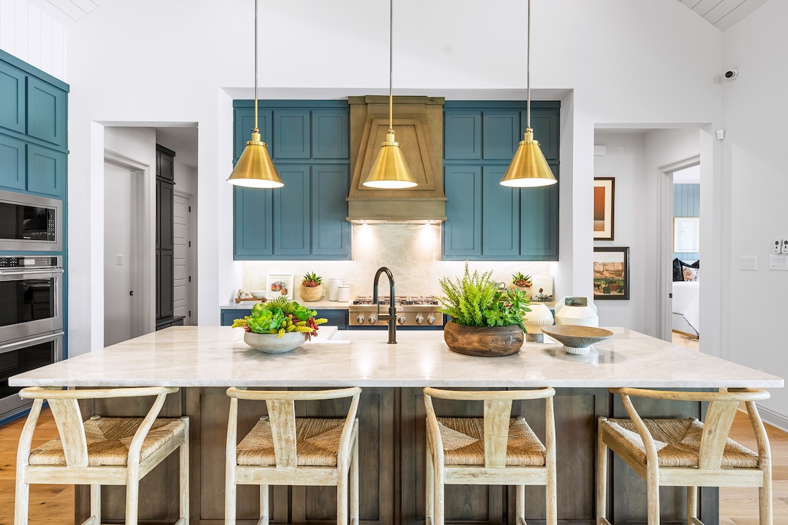 modern kitchen with colored cabinets and gold light fixtures