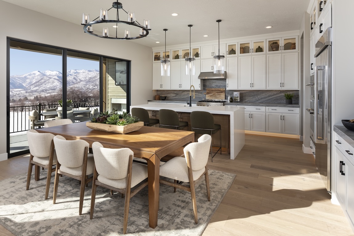 modern kitchen with a dining table and views of the mountains in the distance
