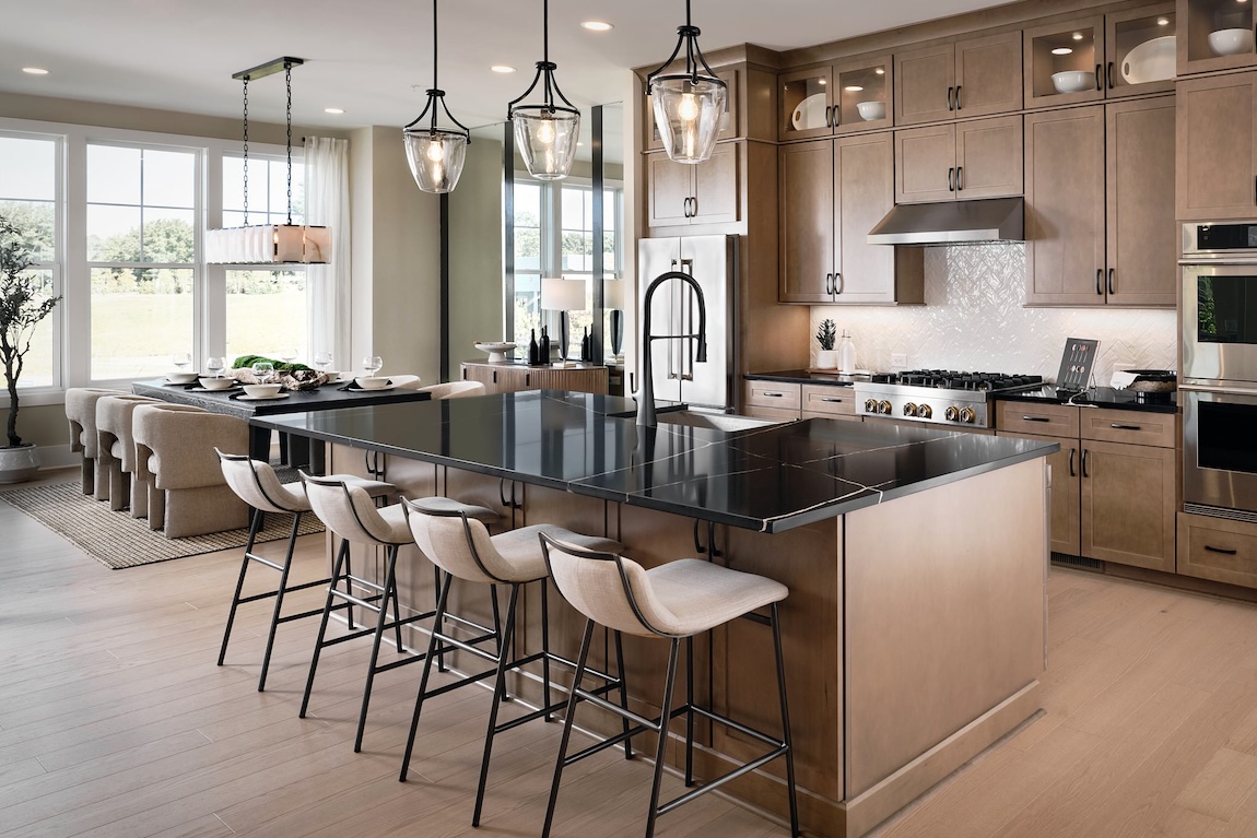 modern kitchen with black countertops and brown cabinetry
