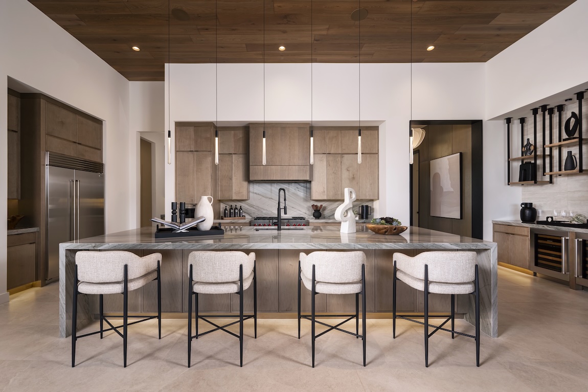 large kitchen with waterfall island and statement lighting
