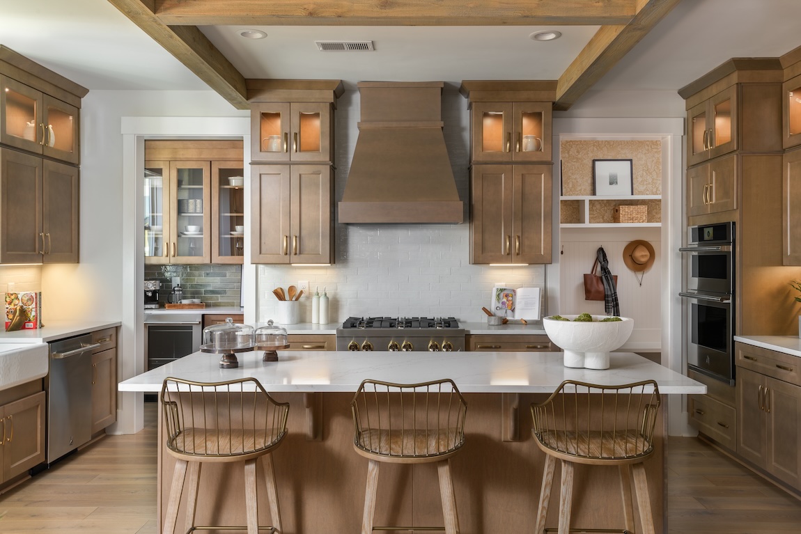 modern kitchen with wood cabinetry and marble countertops