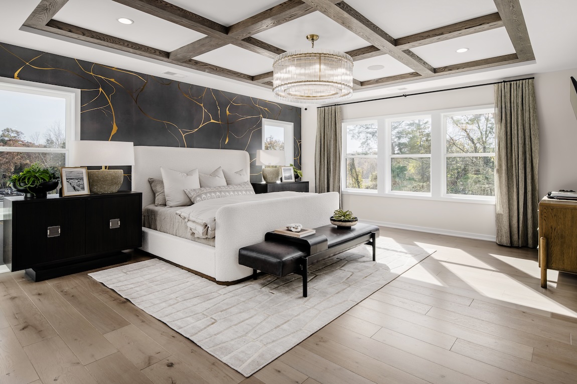 primary bedroom with black accent wall and natural light