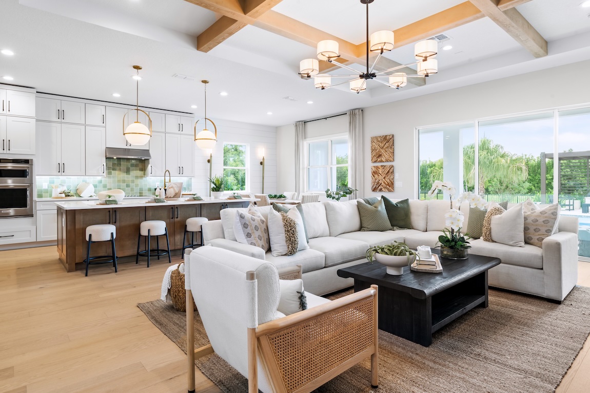 open-concept living room and kitchen with large glass doors to the outdoor living space