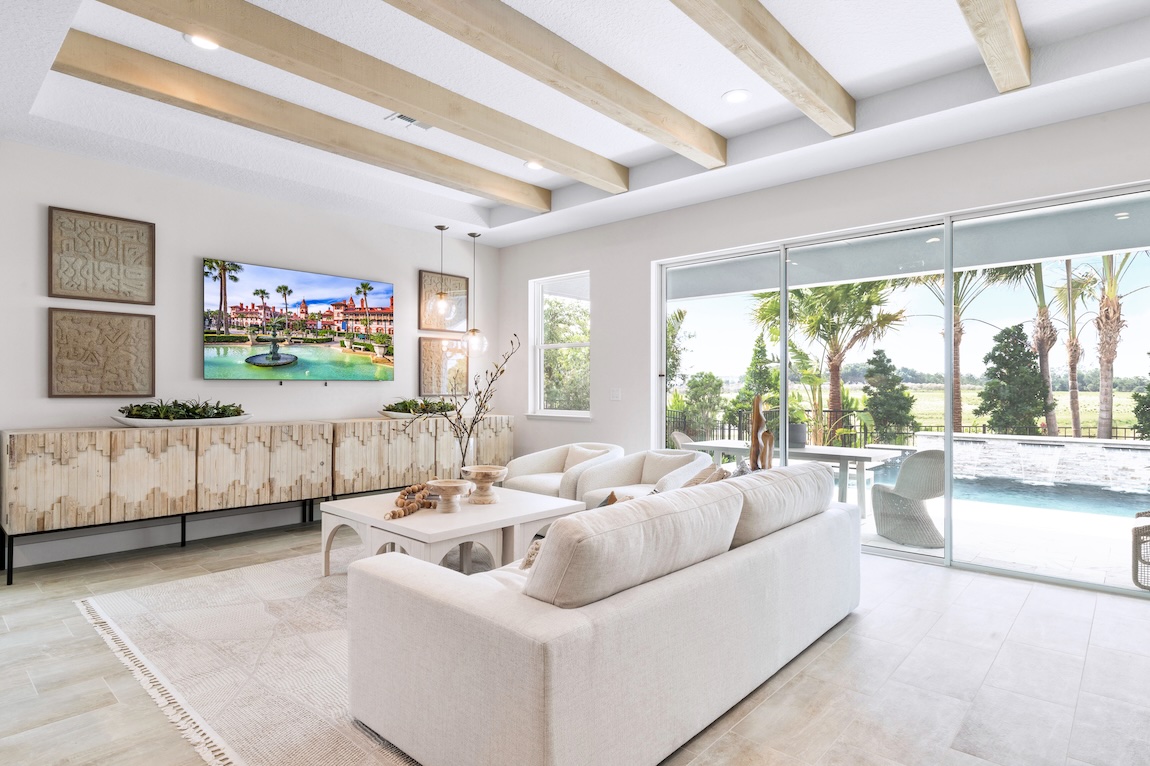 luxury home design that maximizes the benefits of natural light with expansive sliding glass walls that connect the great room to patio