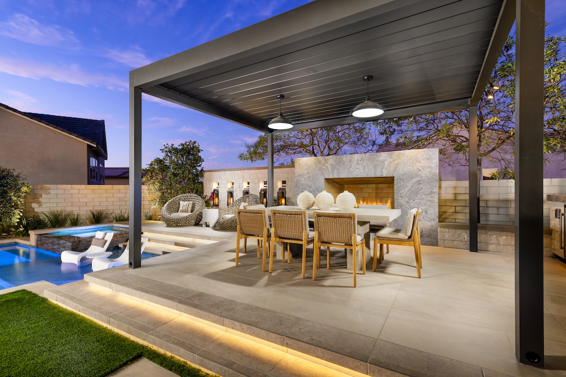 outdoor dining space with luxury fireplace and pool