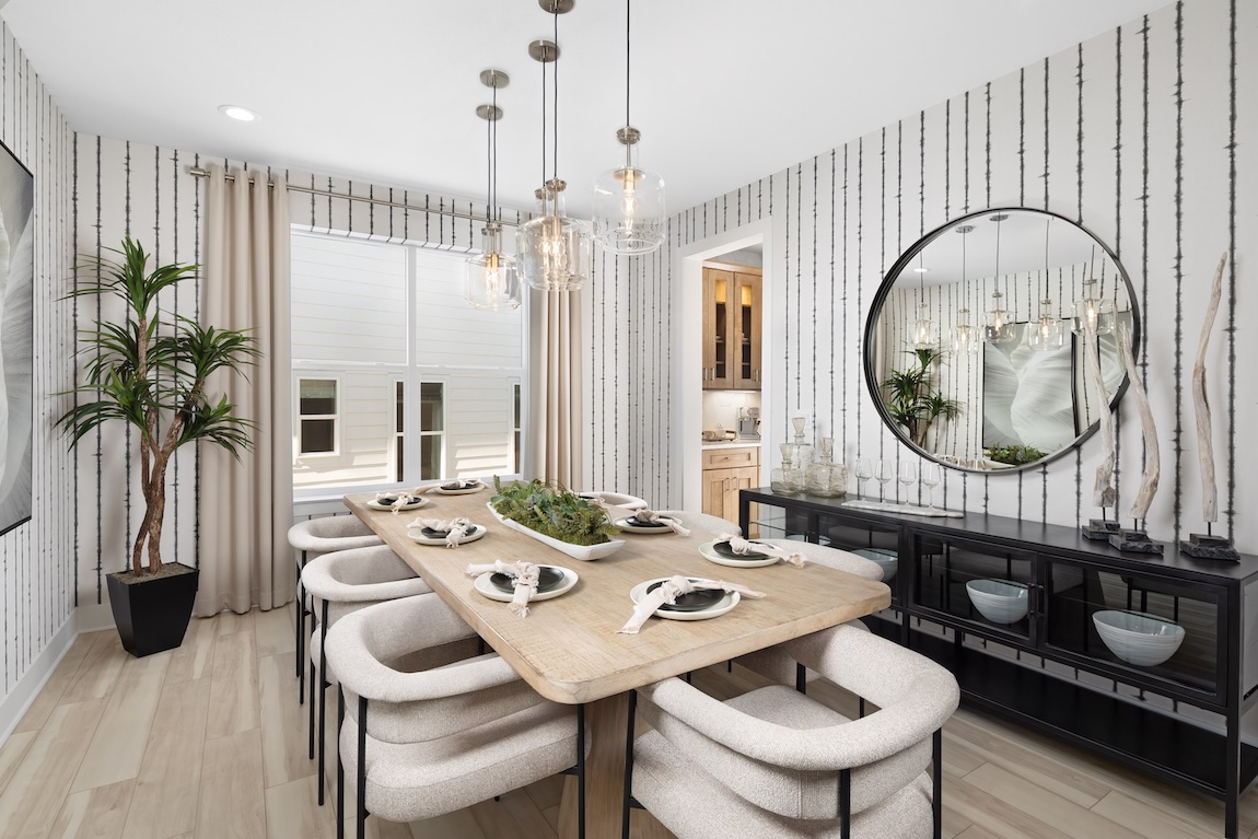 dining room with vibrant wall paper and pendant lighting
