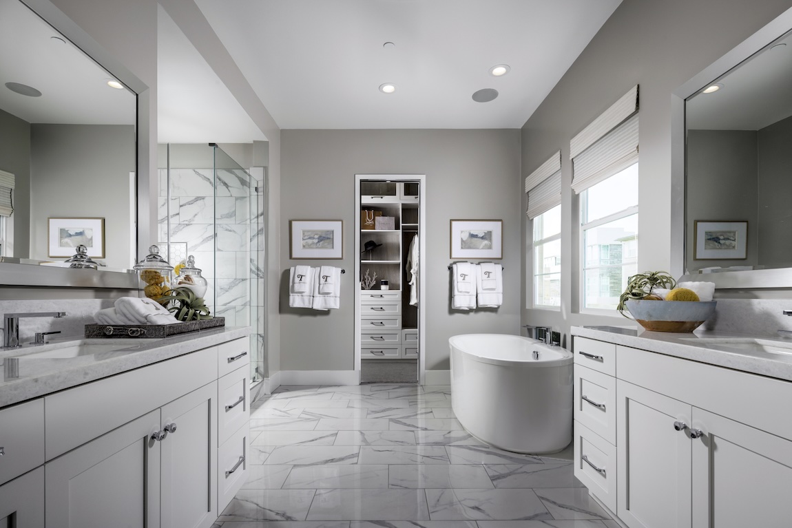 marble bathroom with tile flooring and white cabinetry