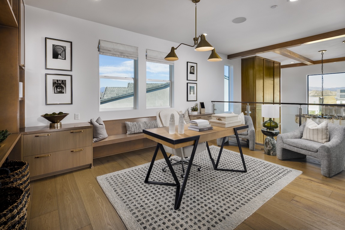 upstairs loft with desk and built-in storage shelves
