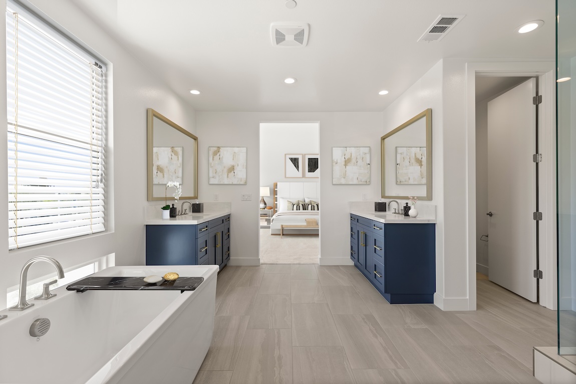 bathroom with navy blue cabinetry under dual sinks