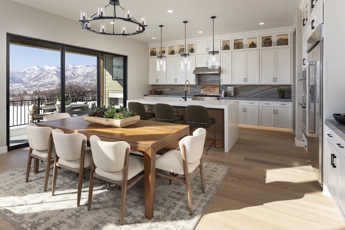 modern dining and kitchen space with wooden furniture and mountain views