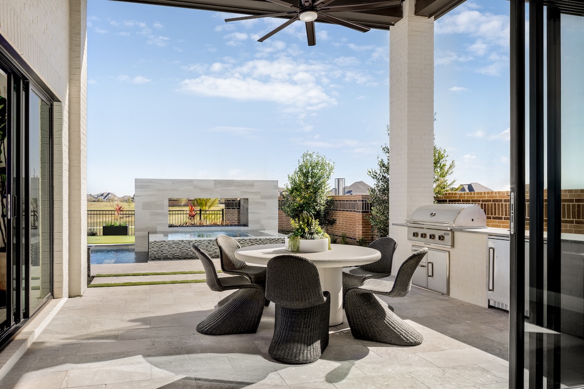 outdoor dining space with grill and table