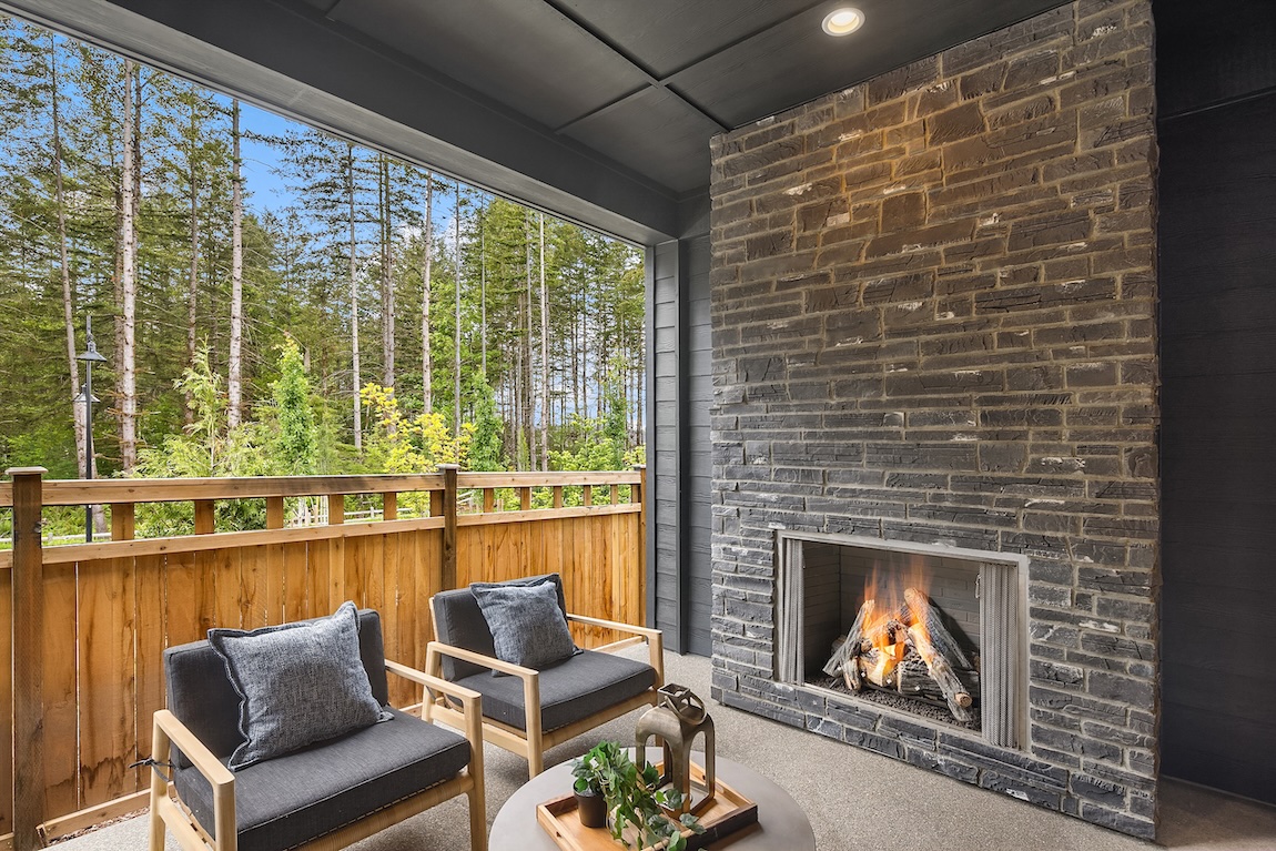 outdoor living space with chairs and a fireplace