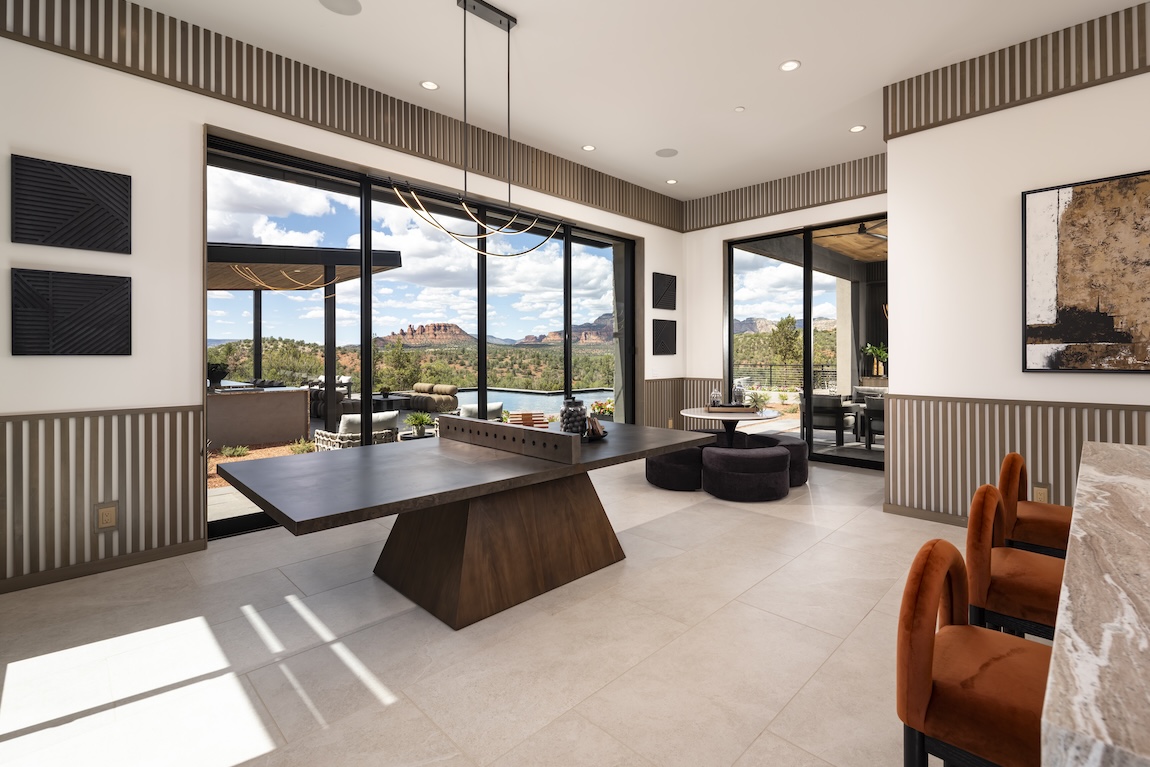 indoor-outdoor living space with ping pong table and views of the mountains