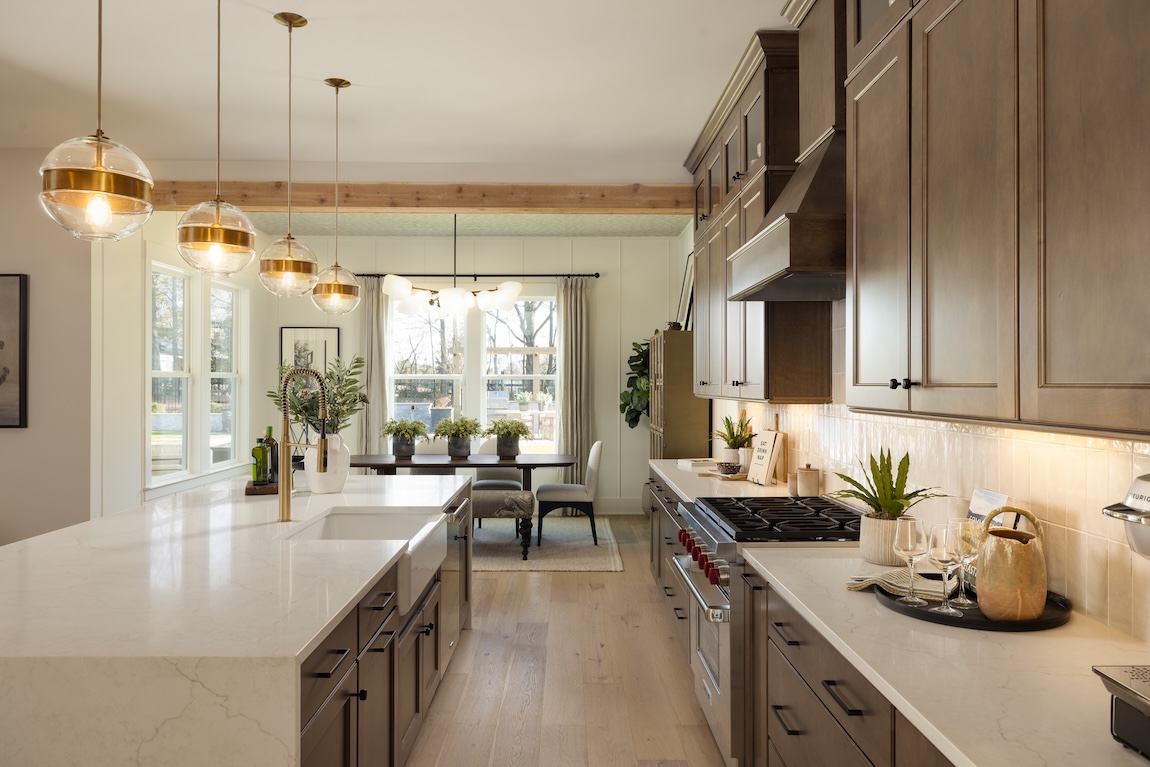 luxury kitchen with wooden cabinetry and greenery