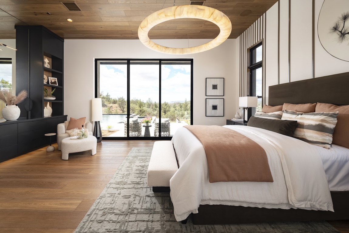 primary bedroom with glass doors leading to the outdoor living space