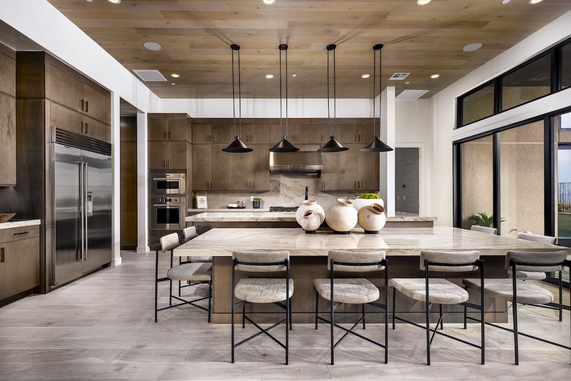 modern kitchen with wooden cabinetry with large island and dining table