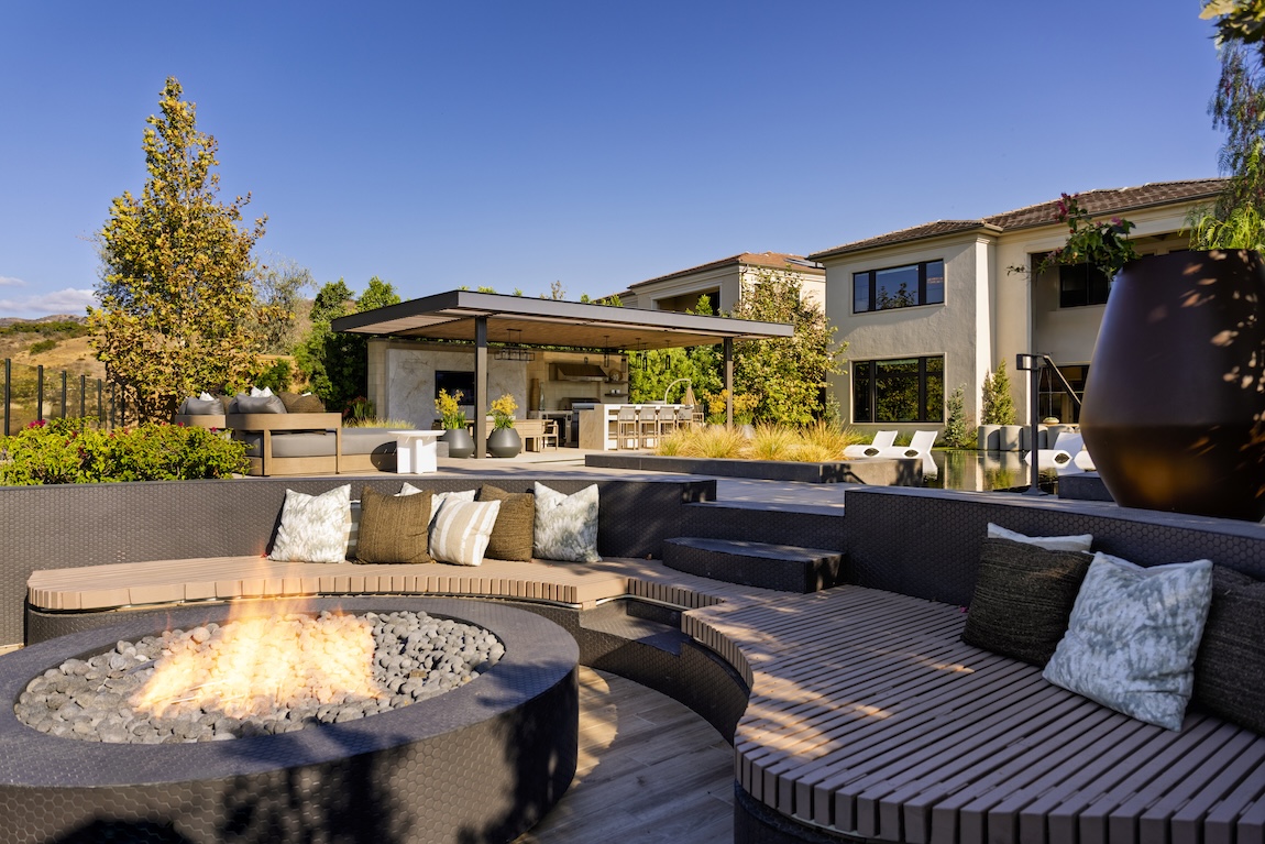 fire pit with outdoor living space in the background