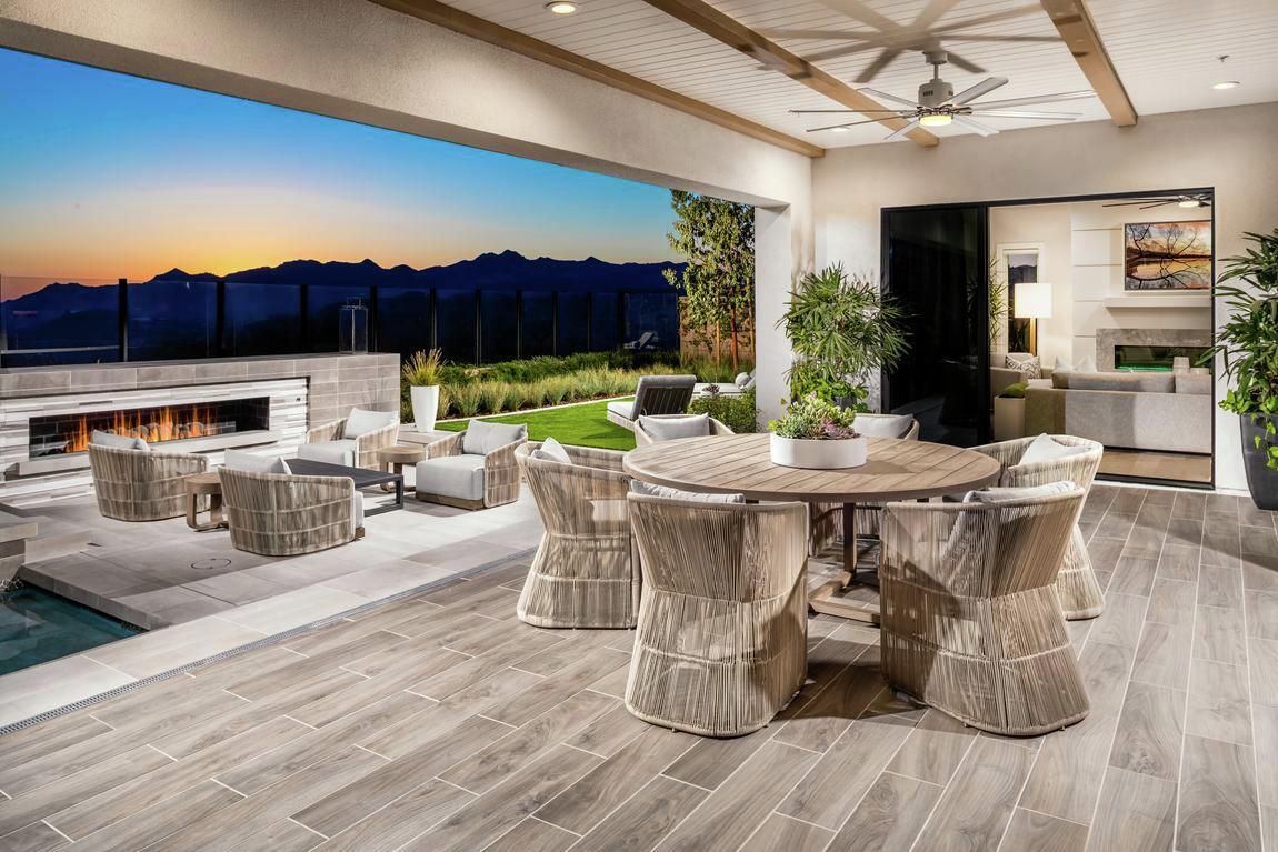 Coastal patio with woven furniture and luxe fireplace lounge
