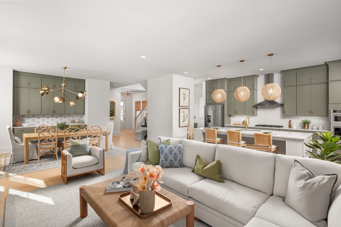 living room and kitchen with green cabinetry and greenery