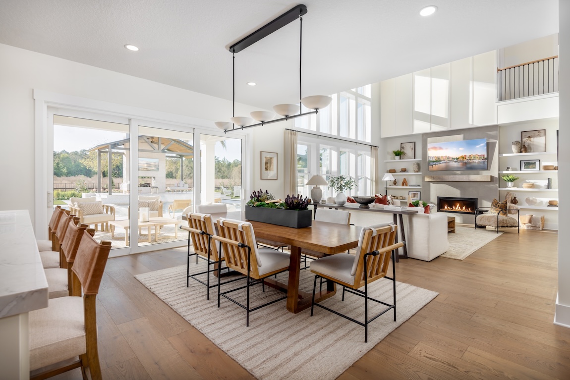 dining and living space with neutral walls and sliding glass doors to the outdoors