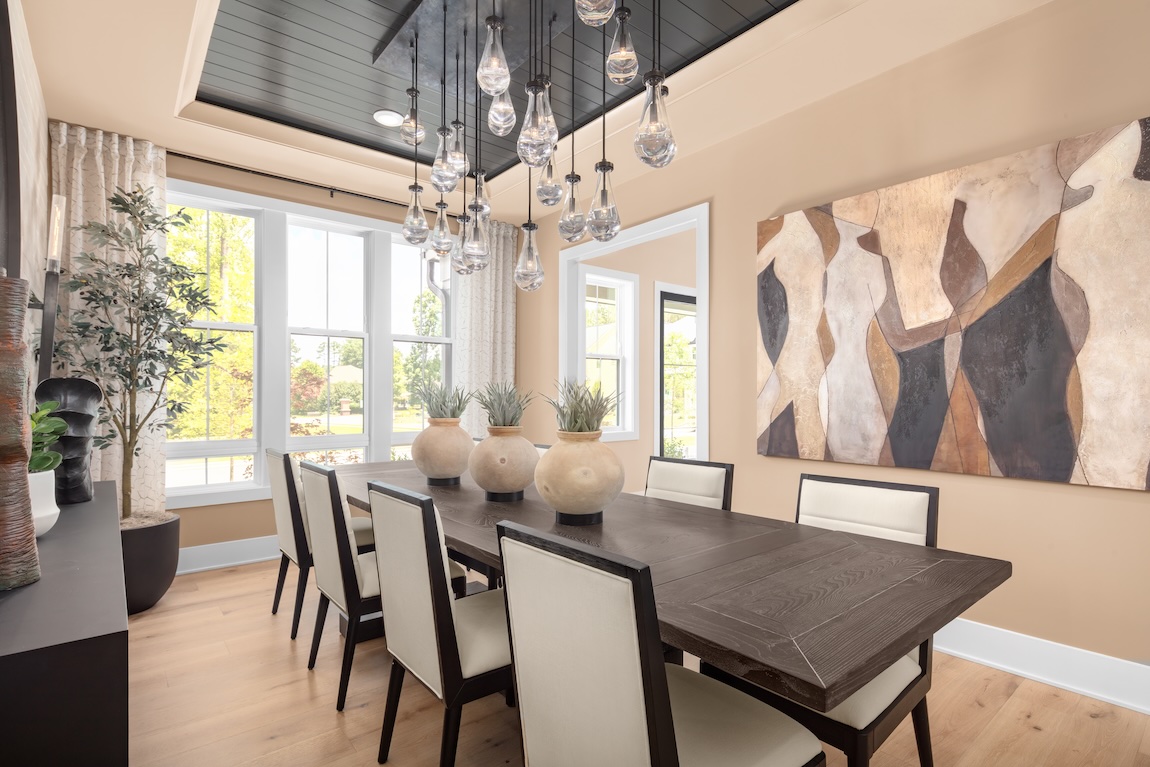 modern dining room with neural color chairs and statement lighting
