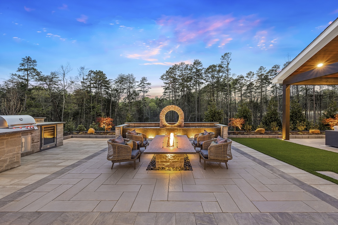 outdoor fire pit space with grill and seating