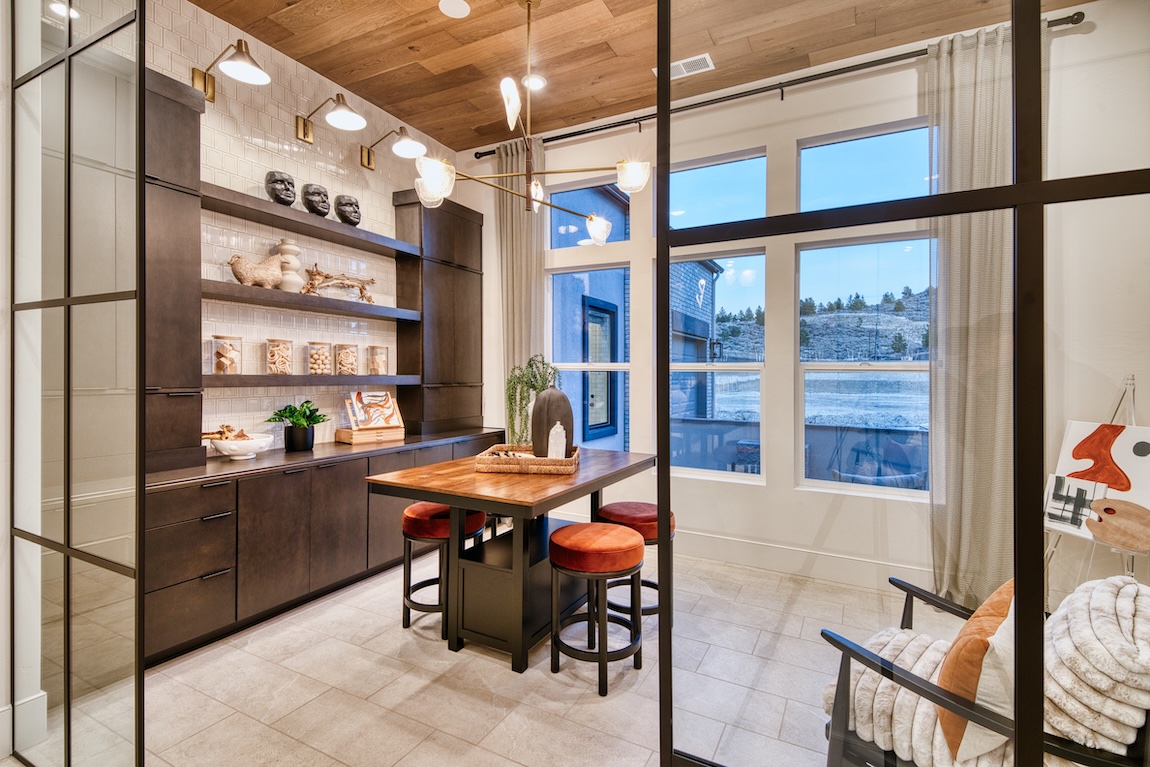 Cozy flex room with warm wood cabinetry, rust-colored seating, and mixed natural textures