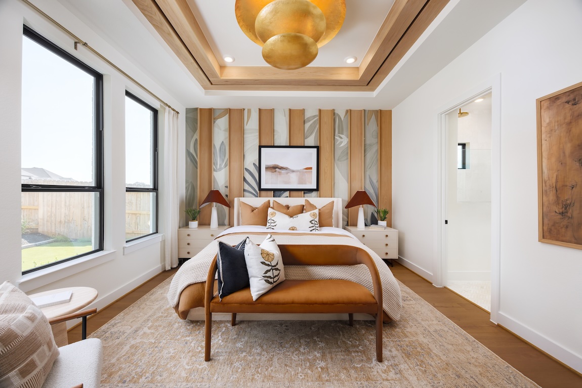 Fall bedroom design with warm caramel bedding, natural wood accents, and layered botanical details
