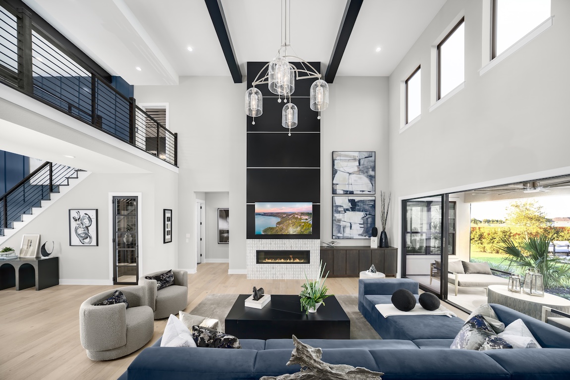 living room with navy sectional sofa and black hues