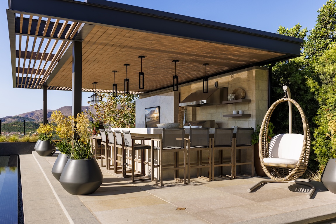 outdoor bar space with seating and views of the pool