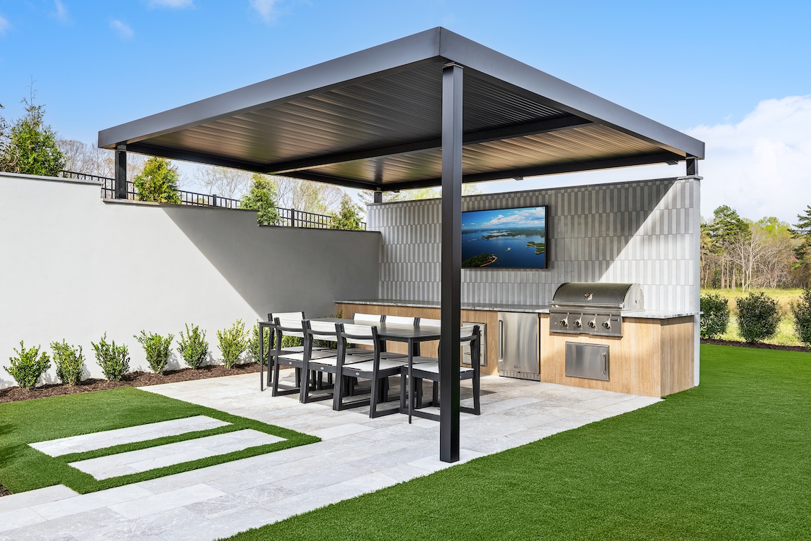 outdoor dining space with grill and TV