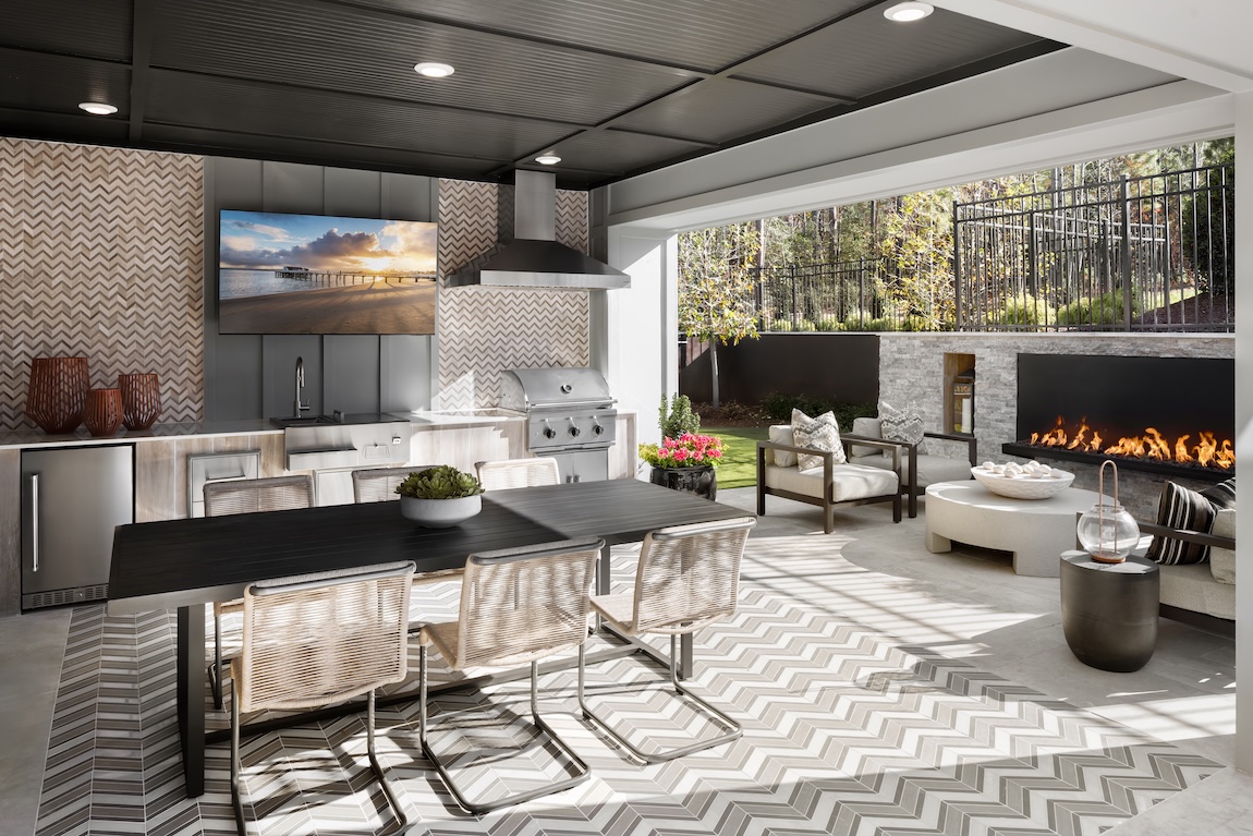 outdoor living space with dining table and views of fireplace