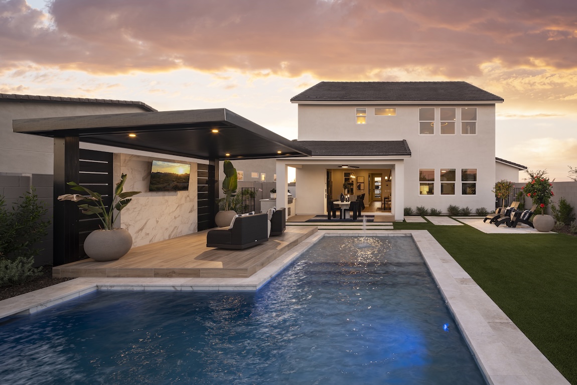 Exterior of home with pool and lounge space with TV