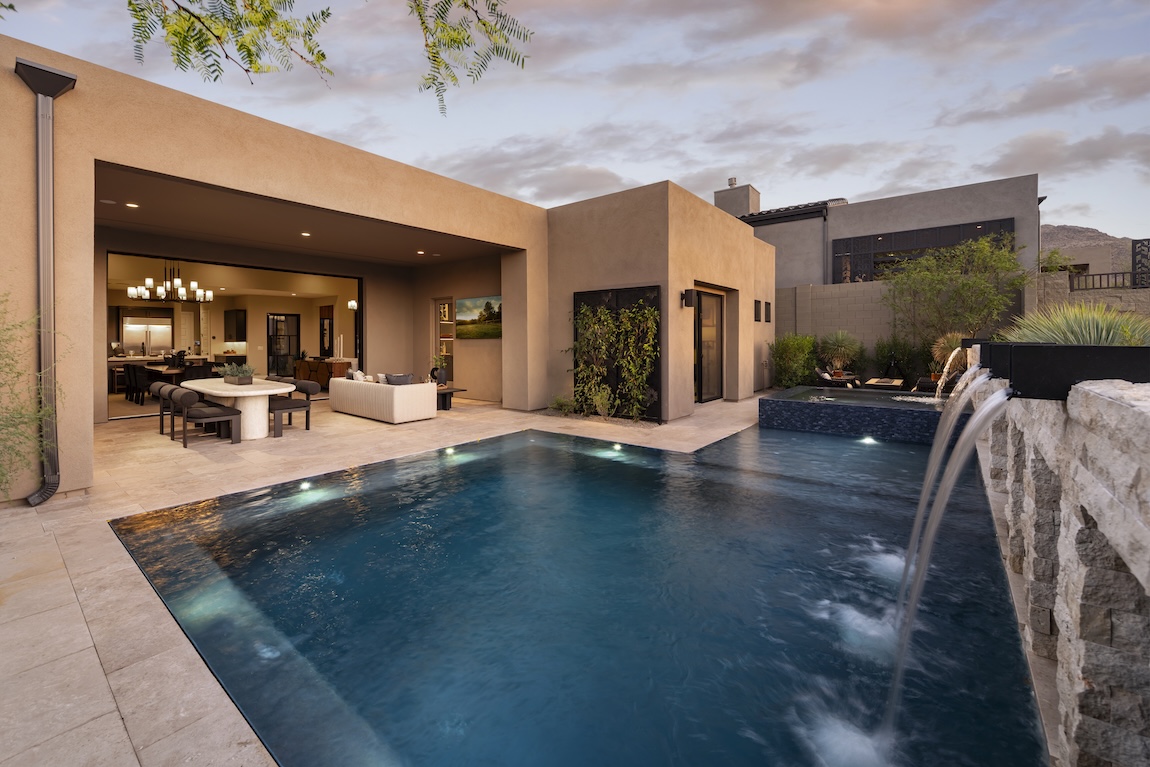 outdoor pool with water features and access to the indoor space