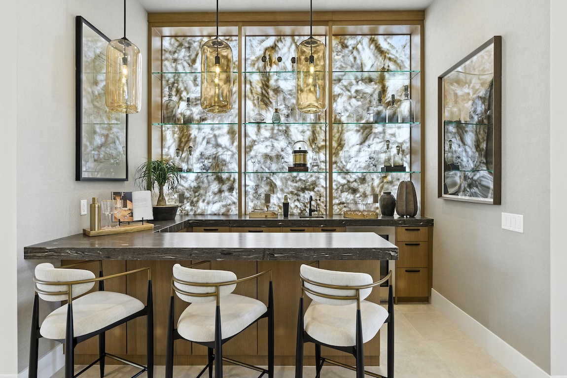 Home bar with gold fixtures and island seating