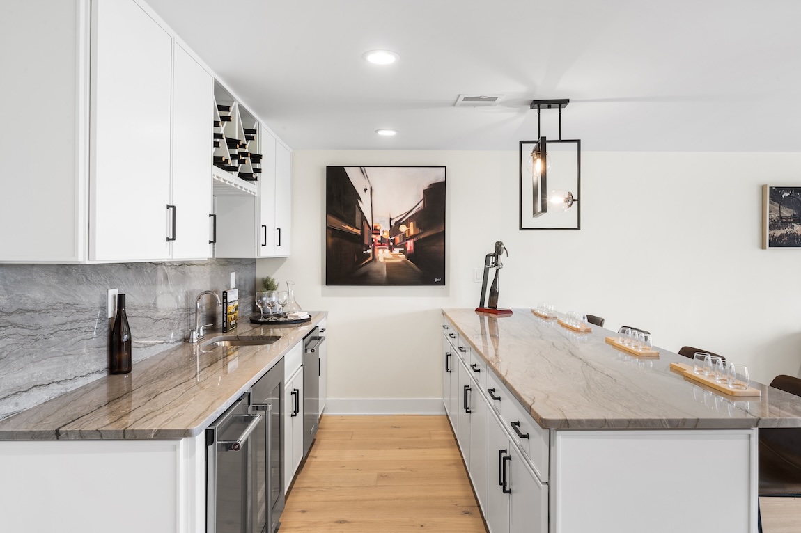 Basement bar with island and glasses for serving