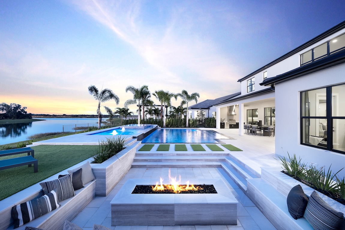 backyard with pool and fire pit overlooking the water.