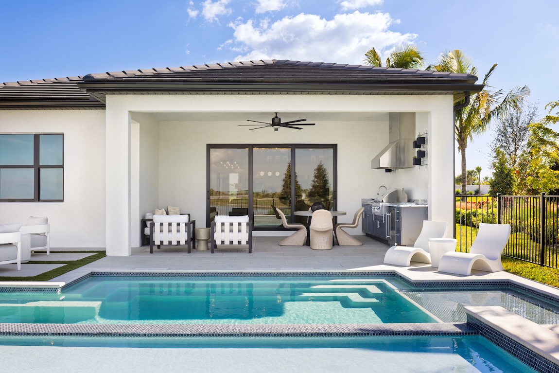 outdoor covered patio next to a luxury pool