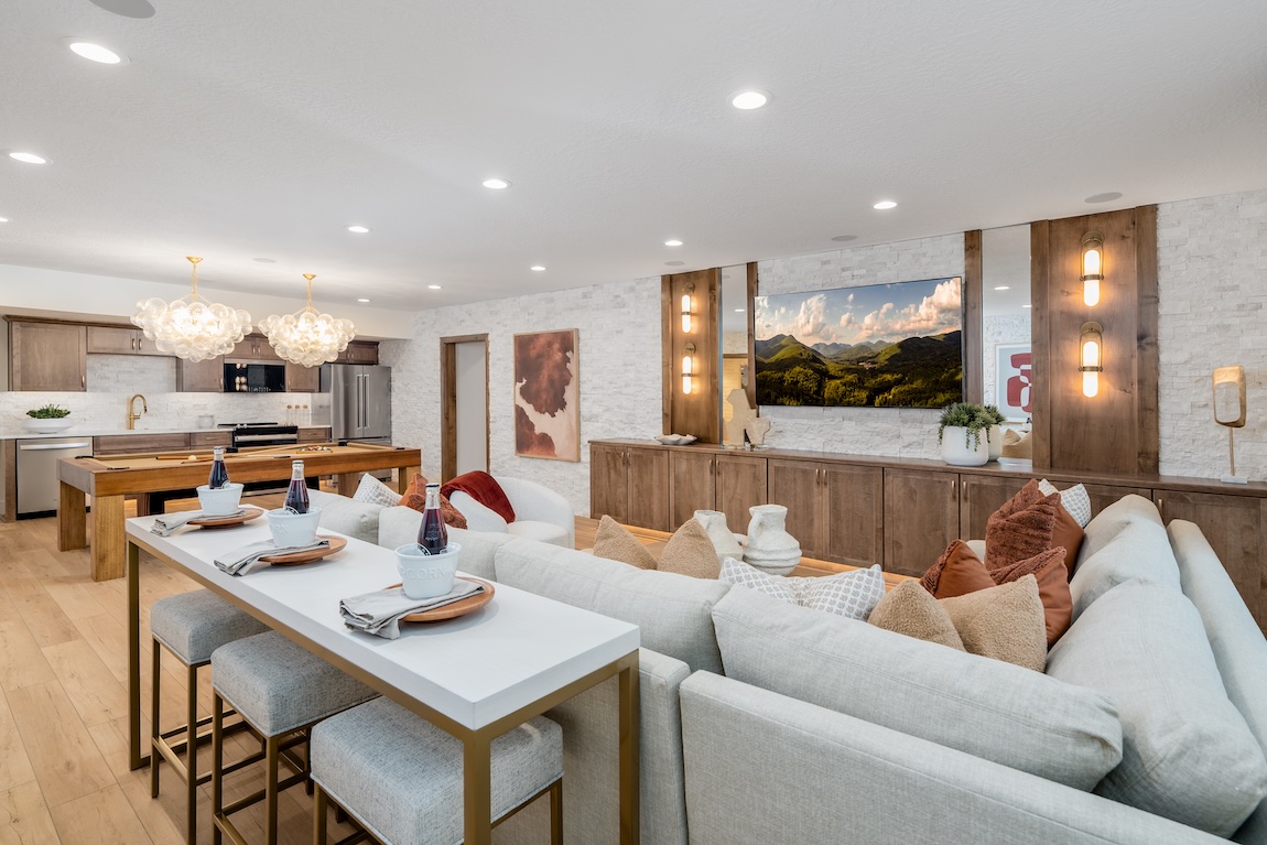 finished basement with sectional sofa and pool table