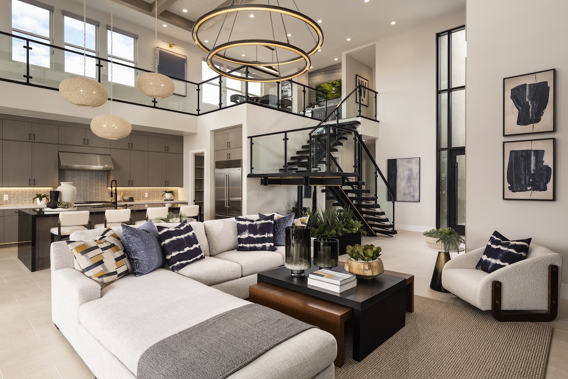 modern great room with floating staircase in the background