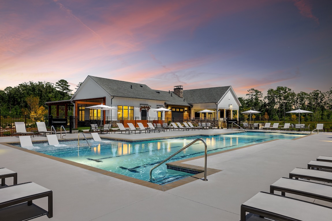 community pool and clubhouse with lounge seating.