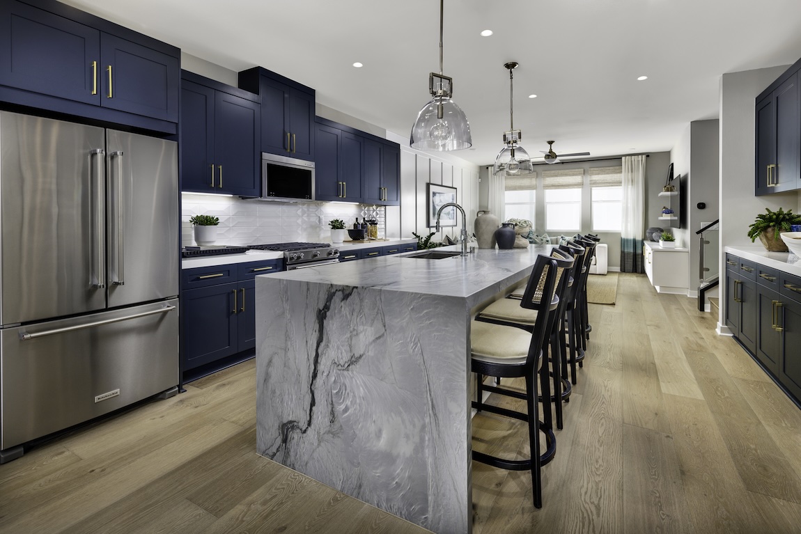 modern kitchen with navy blue cabinetry and waterfall island