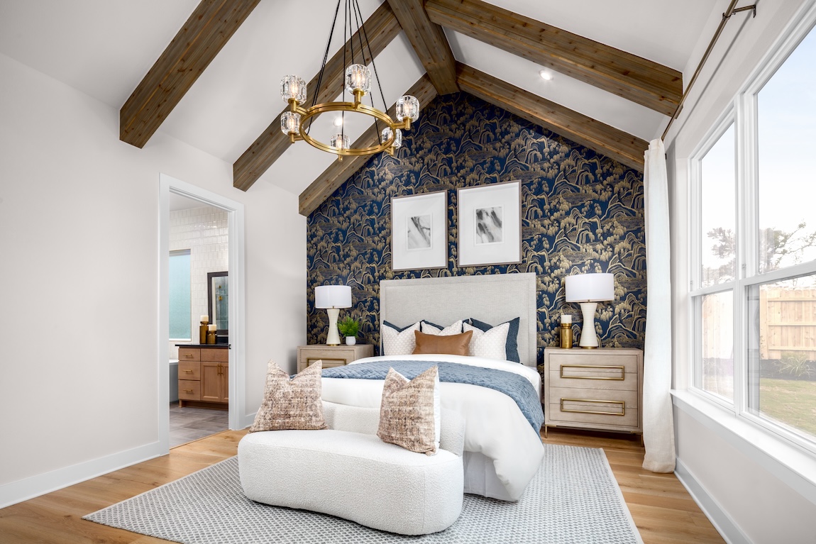 primary bedroom with elegant wallpaper accent wall
