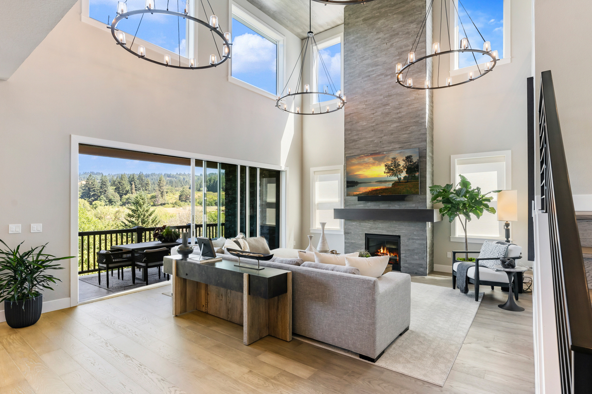 two-story great room with fireplace featuring accent wall