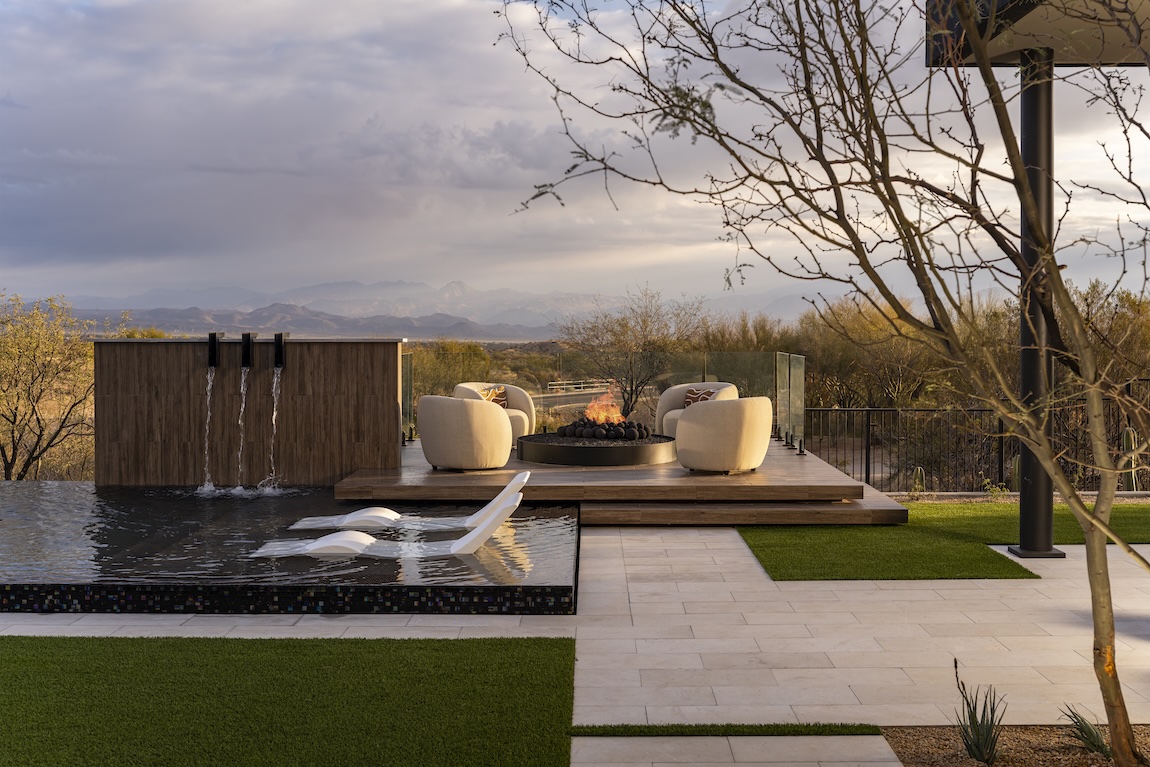 outdoor fireplace setting next to pool.