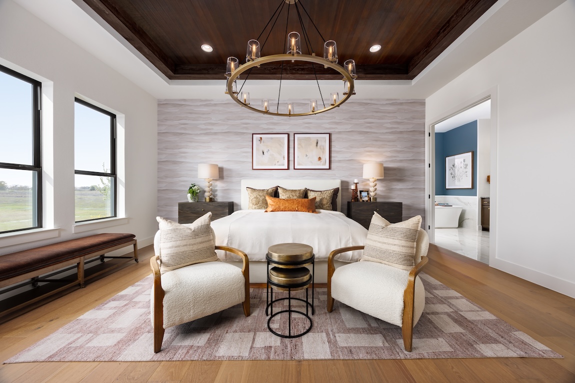 primary bedroom with earthy colors and an accent wall