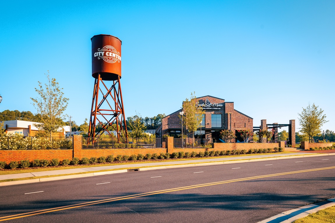 Cumming City Center featuring artistic water tower and restaurant 