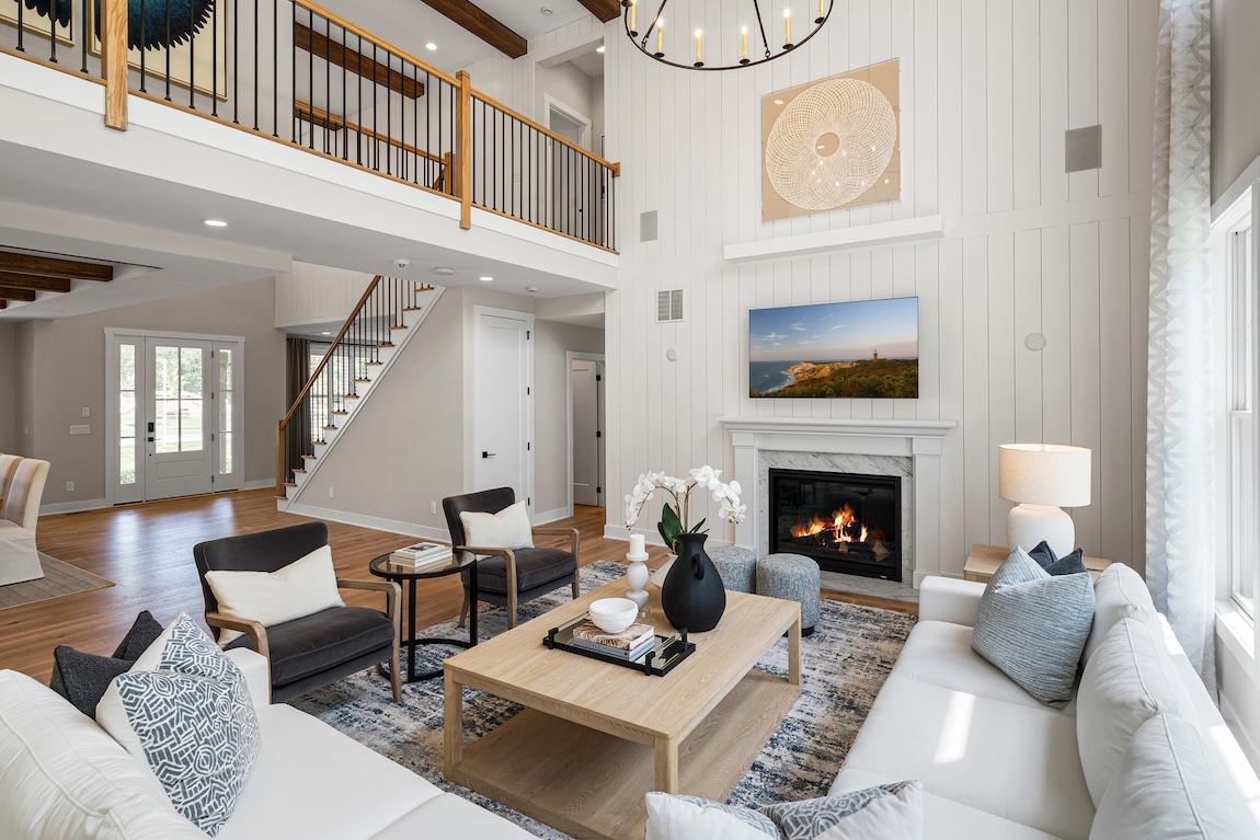 Bright great room with vaulted ceiling and cozy fireplace as the focal point.