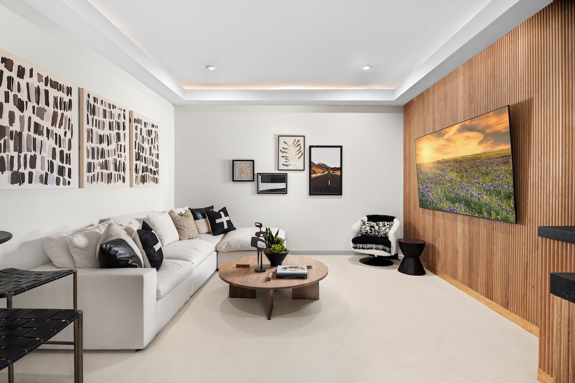 Flex room with wall art and wood accented wall.