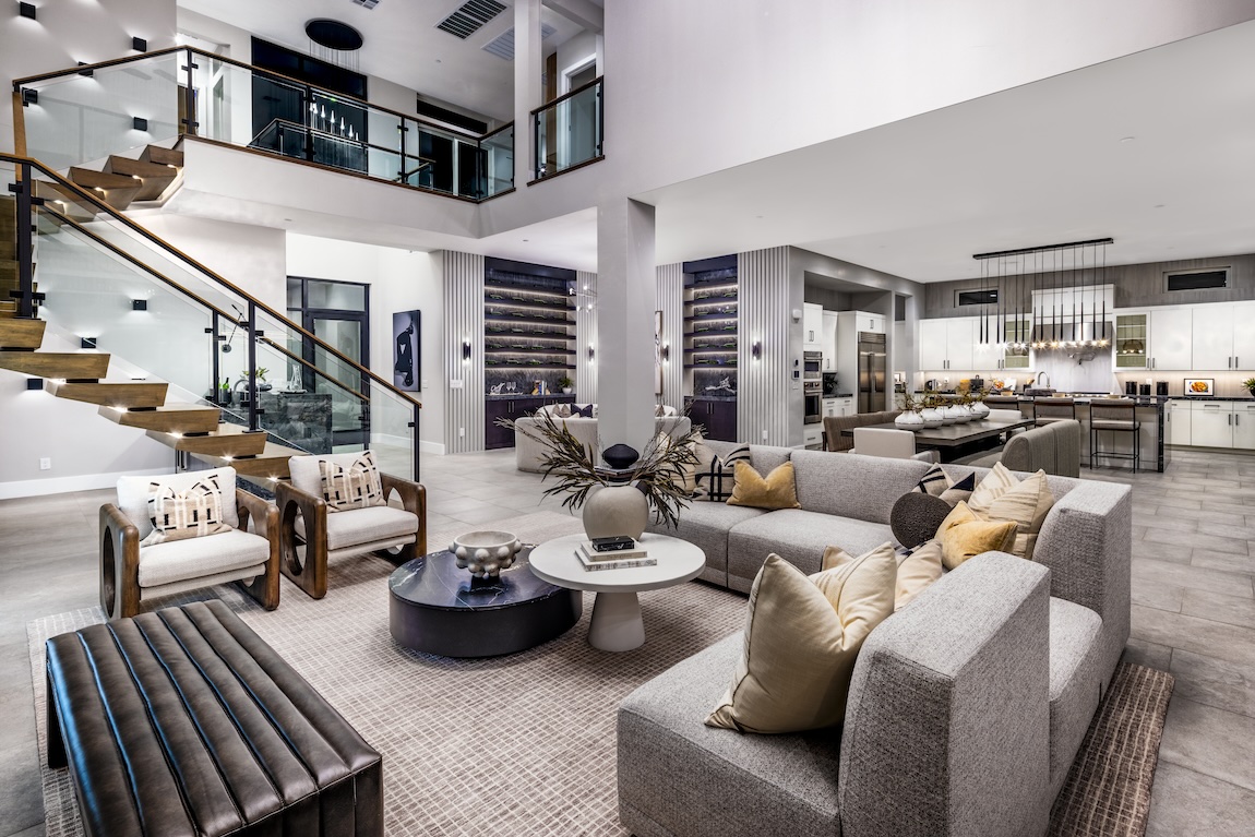 Expansive contemporary interior design featuring impressive staircase and eye-catching kitchen lighting